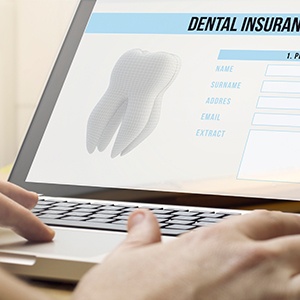 Filling out dental insurance form on a laptop