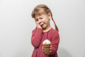 little girl holding an ice cream cone with tooth sensitivity